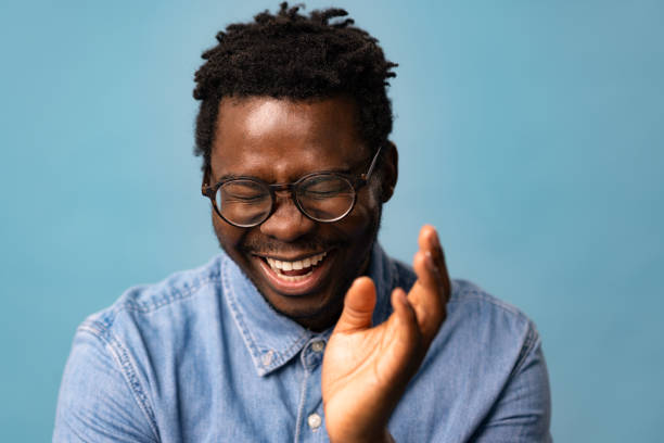 istock Cheerful black man having fun against blue background. 1469154311