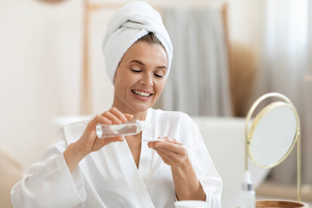 istock Attractive middle aged woman using face tonner and cotton pads 1469154352