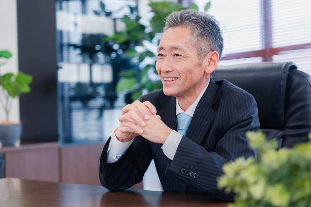 A smiling company executive in the boardroom stock photo