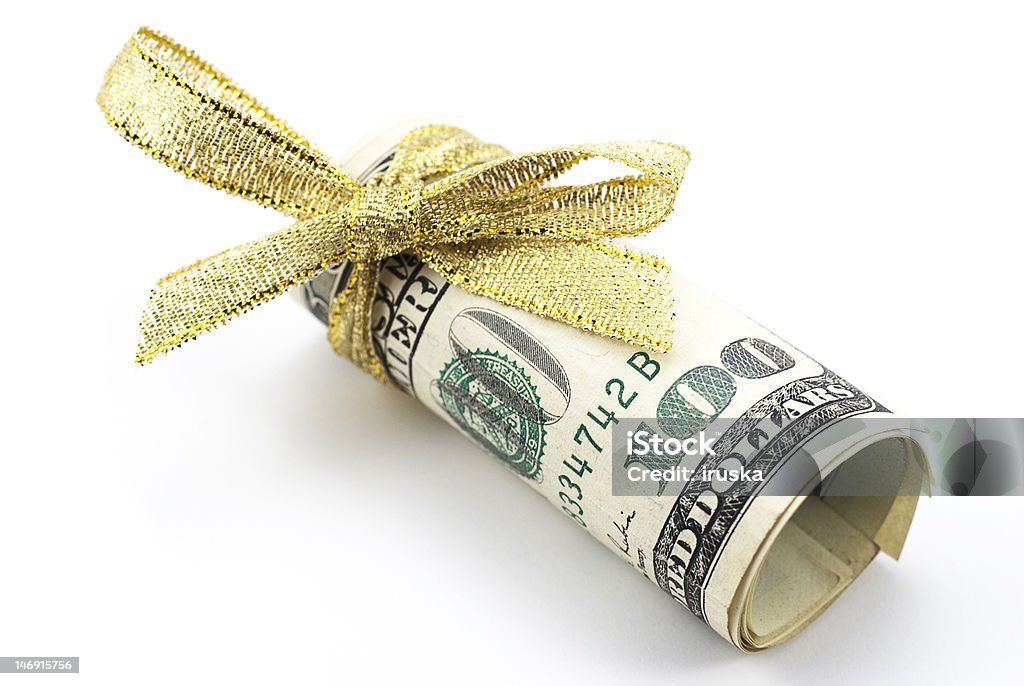 One hundred dollar bills with gold ribbon One hundred dollar bills with gold ribbon, the best present Currency Stock Photo