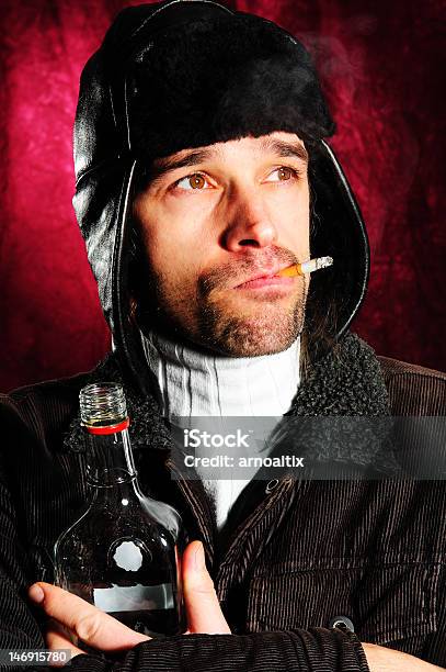 Young Man With Cigarette Bottle And Coat Cap Stock Photo - Download Image Now - Russian Ethnicity, Vodka, Adult