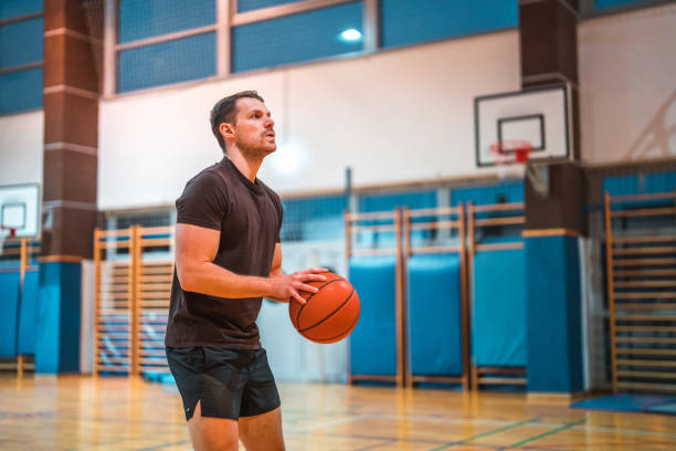 istock Caucasian Male Basketball Player Practicing Free Throws 1469157910
