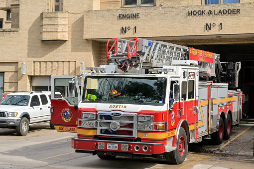 Austin, Texas, USA - February 2023: Fire engine with ladder parked outside the fire station in the city centre