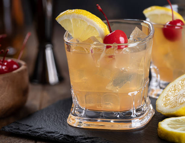 istock Whiskey sour cocktail with cherry and lemon 1469159277