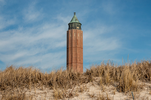 The Robert Moses Water Tower sticking up over the sand dunes with beach grass on Fire Island State Beaches.
