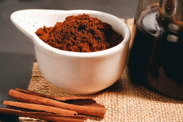 istock Black coffee and cinnamon sticks. Aromatic coffee from freshly ground coffee grounds 1469161299