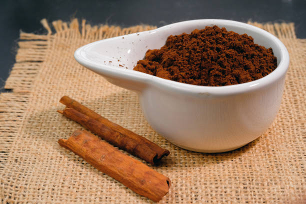 istock Real coffee grounds in a bowl with cinnamon sticks on a burlap napkin 1469161614