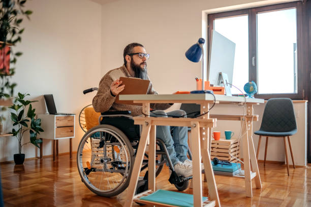 istock Man in wheelchair working from home 1469162460
