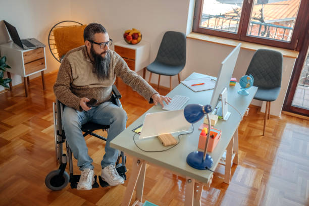 istock Man in wheelchair working from home talking on mobile phone 1469163497
