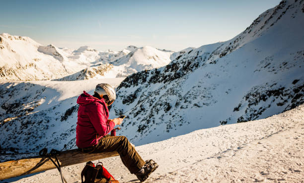 Female skier using smartphone