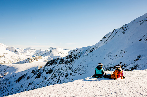 Skiers resting on the top of mountain