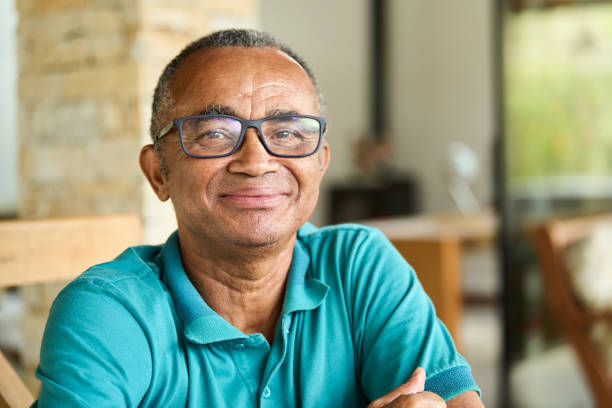 istock Mature man smiling while sitting on his patio at home 1469164870