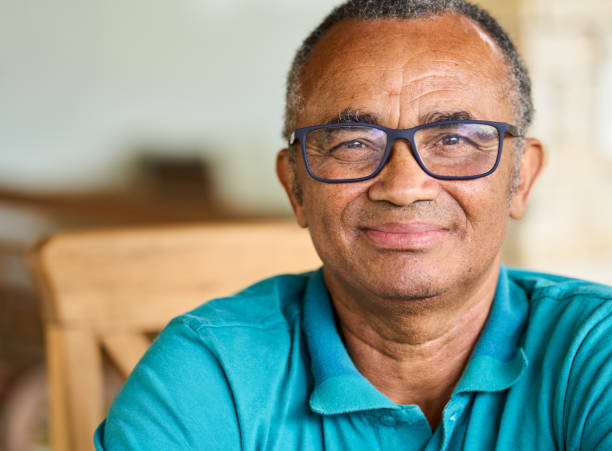 istock Mature man smiling while sitting outside on his patio at home 1469164877