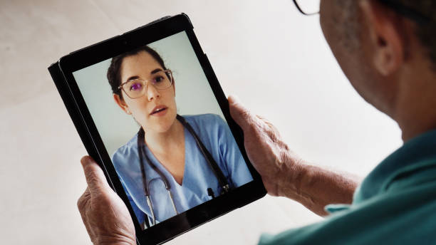 istock Mature man having an online doctor's consultation using a tablet 1469165218