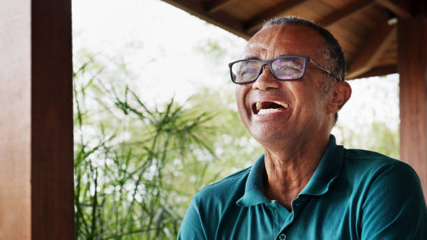 istock Mature man laughing while sitting outside on his patio at home 1469165267