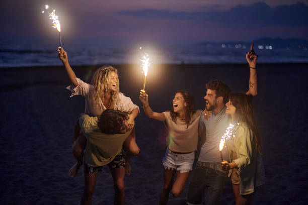 istock Cheerful friends having fun with flaming torches by night. 1469166423