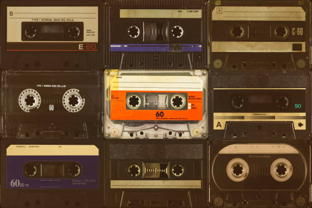 istock Orange compact cassette in front of black audio tapes 1469166719