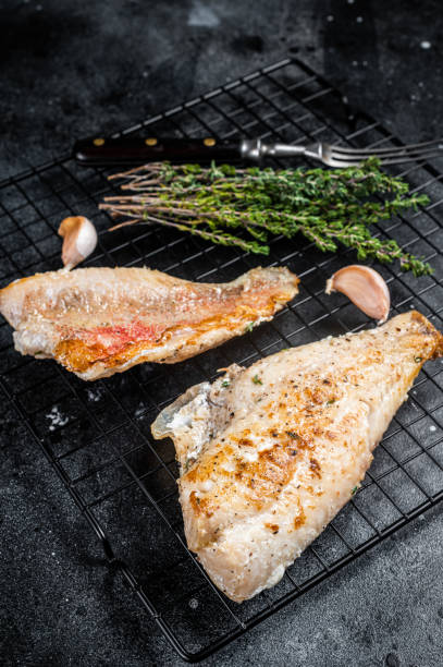 istock Grilled sea red perch fillet, Snapper fish on a rack. Black background. Top view 1469168182