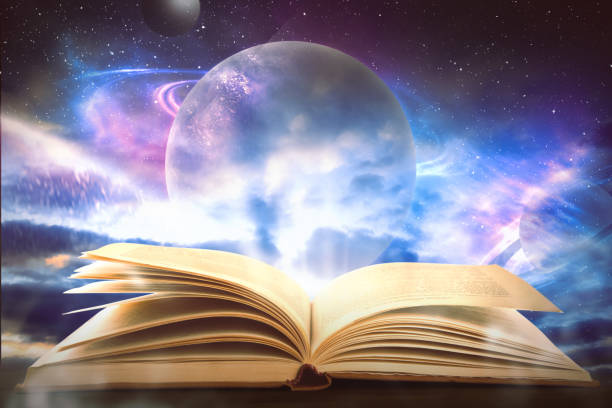 istock Wooden table with open book and beautiful universe on background 1469168917
