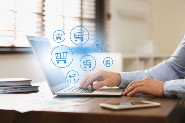 istock Man using laptop for online shopping at wooden table, closeup 1469169106