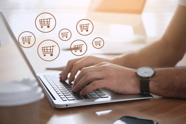 istock Man using laptop for online shopping at wooden table, closeup 1469169208