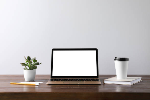 istock Workplace with modern laptop on wooden table. Mockup for design 1469169684