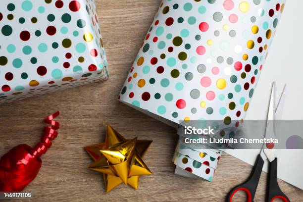 Roll Of Wrapping Paper Scissors Gift Bow And Box On Wooden Table Flat Lay  Stock Photo - Download Image Now - iStock