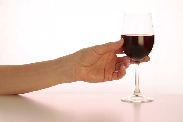 istock Hand reaching for Glass of Red Wine 146917138