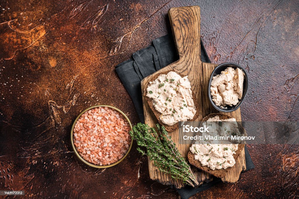 Cod Liver open Sandwich on wooden board. Dark background. Top view Cod Liver open Sandwich on wooden board. Dark background. Top view. Can Stock Photo