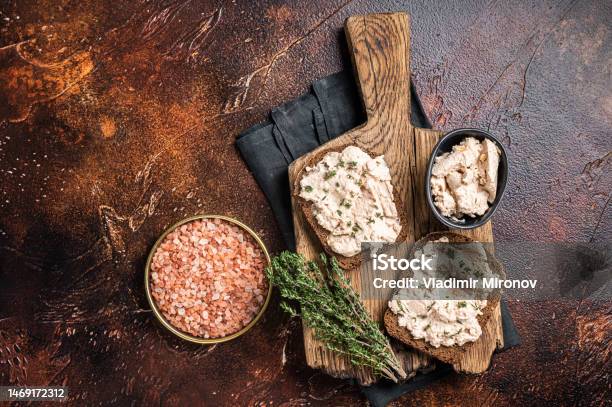 Cod Liver Open Sandwich On Wooden Board Dark Background Top View Stock Photo - Download Image Now