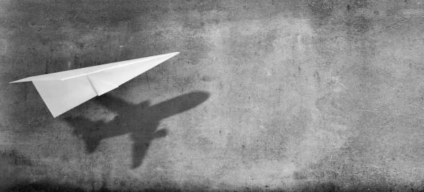 istock Big idea, startup and motivation concept. Paper plane with shadow on concrete wall background. 1469174424