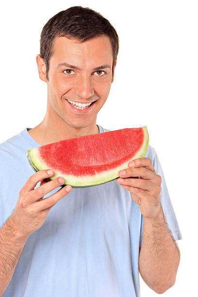 istock Smiling young man showing a slice of watermelon 146917559