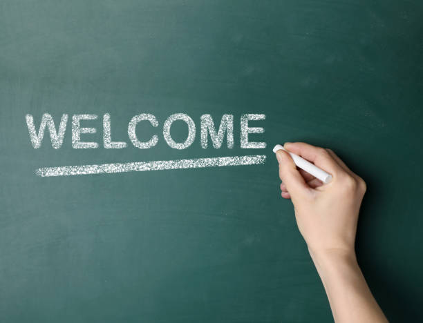 istock Woman writing word WELCOME on chalkboard, closeup 1469176991