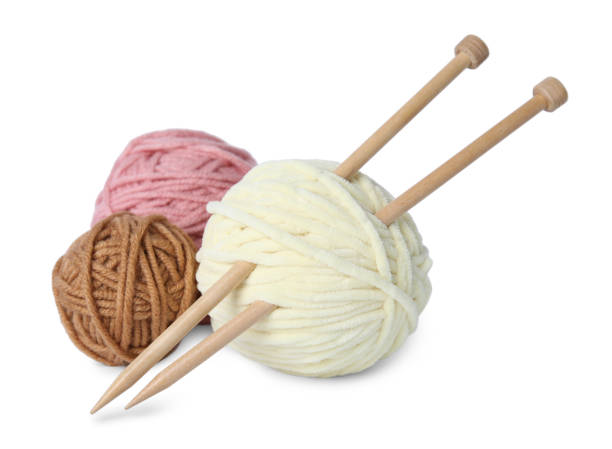 istock Soft woolen yarns and knitting needles on white background 1469177205