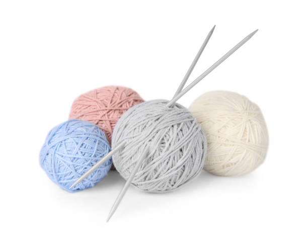 istock Soft woolen yarns and knitting needles on white background 1469177722