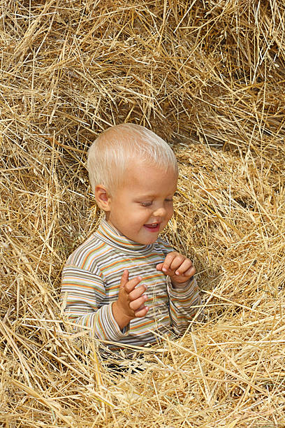 boy in straw stock photo