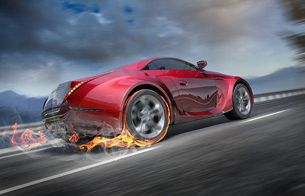 Flames coming from back of fast moving sports car stock photo