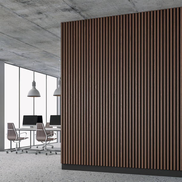 A side view of a semi-empty office interior with copy space and work desks on a terrazzo floor and brown hardwood paneled wall