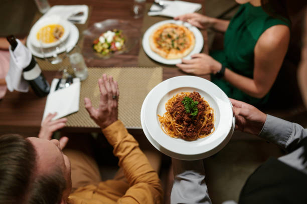 istock Waiter Serving Spaghetti Bolognese 1469182212