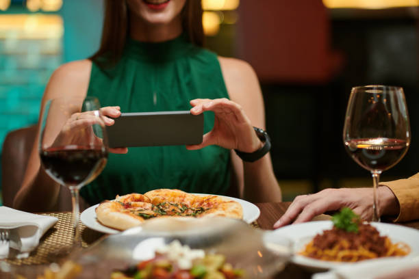 istock Woman Photographing Dinner in Restaurant 1469182228