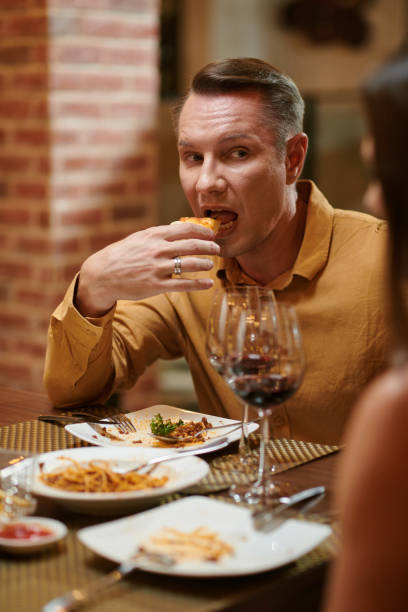 istock Man Biting Slice of Pizza 1469182232