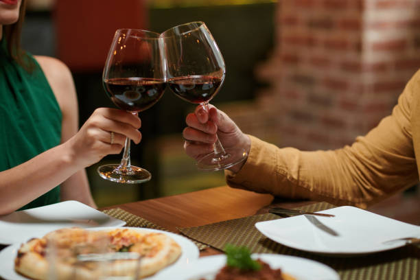istock Couple Clinking Wine Glasses 1469182259