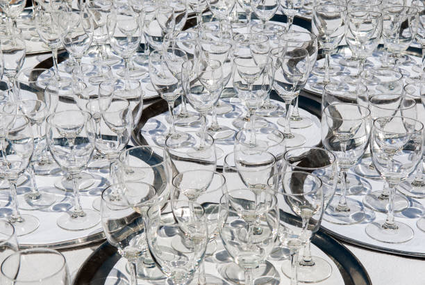 close up Crowd of empty crystal glasses on waiter trays