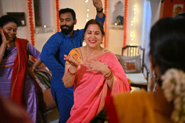 istock Indian Mulit-generation family and friends dancing together during a family function 1469185059