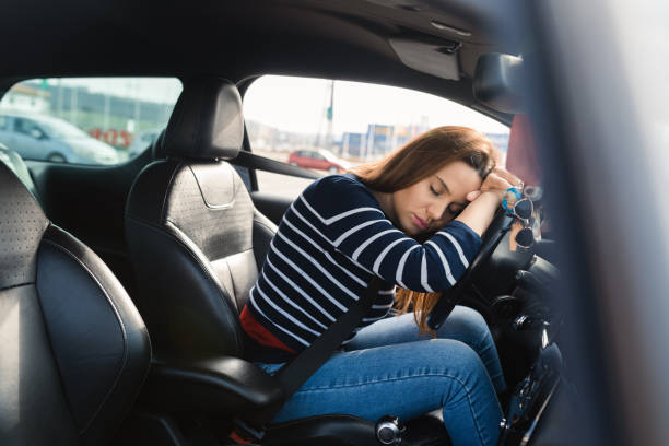 istock Woman sleeping in the car after a long drive 1469185228