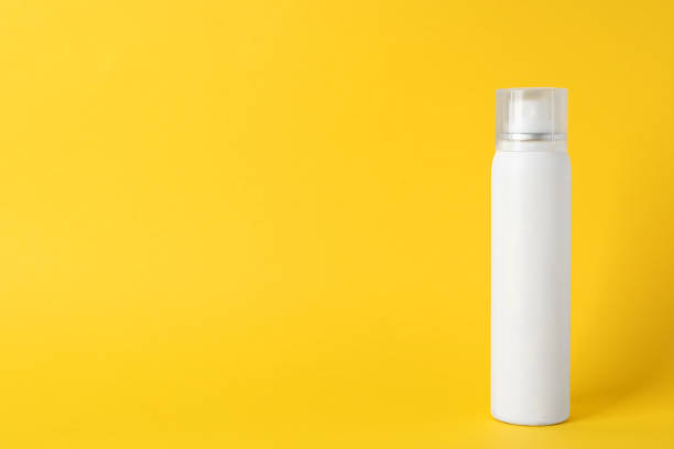 istock Bottle of dry shampoo on yellow background, space for text 1469190956
