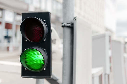 Traffic light on city street, space for text