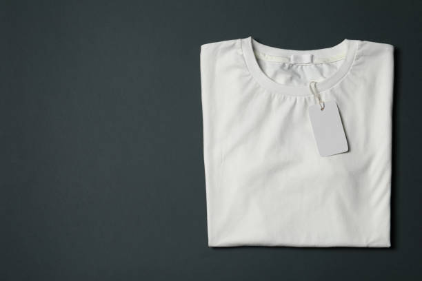 istock Stylish T-shirt with label on black background, top view. Space for text 1469191331
