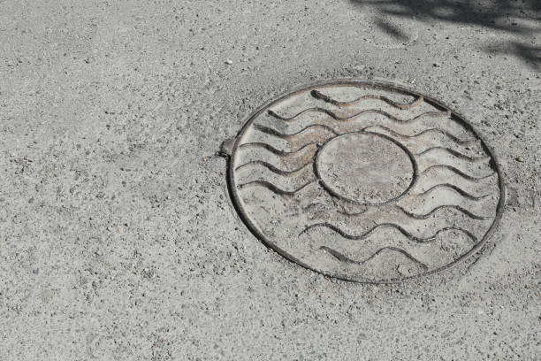 istock Metal sewer hatch on asphalt outdoors, space for text 1469191880