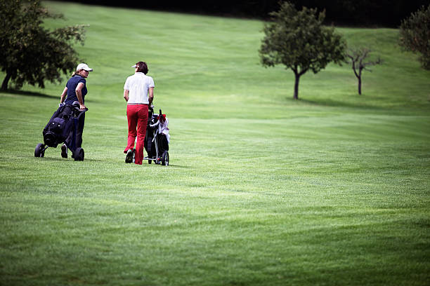 istock Women walking at golf course with trolleys. 146919500